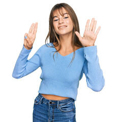 Wall Mural - Teenager caucasian girl wearing casual clothes showing and pointing up with fingers number eight while smiling confident and happy.