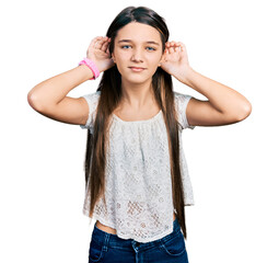 Young brunette girl with long hair wearing white shirt trying to hear both hands on ear gesture, curious for gossip. hearing problem, deaf