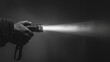 © vefimov - A person's hand holding a flashlight beam against a dark background, emitting bright light and creating a contrast with the darkness