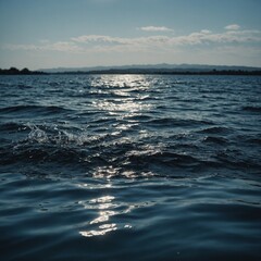 Soft, rolling waves on a sandy beach with a beautiful sunset casting a warm glow