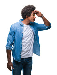 Wall Mural - afro american man over isolated background very happy and smiling looking far away with hand over he