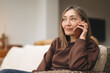 © Iryna - Older Woman Talking on Phone While Sitting Comfortably in Her Living Room