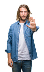 Young handsome man with long hair over isolated background doing stop sing with palm of the hand. Warning expression with negative and serious gesture on the face.