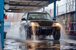 © Anton Pentegov - washing black SUV car at automatic car wash