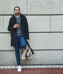 Sticker - Portrait, bag and businessman at wall space for fashion winter style or travel on morning commute in city. Sidewalk, confident or tourist downtown for international work, opportunity or career growth