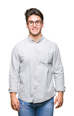 Young handsome man wearing glasses over isolated background with a happy and cool smile on face. Lucky person.