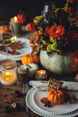 Wall Mural - Elegant atmospheric beautiful dinner table setting for thanksgiving or wedding celebration, fall countryside style, pumpkins as decor. Romantic cozy home atmosphere. Wine, floral pumpkin centrepiece.