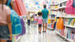 © ZaStock - A parent and child explore aisles of colorful school supplies while other shoppers browse nearby in a busy store