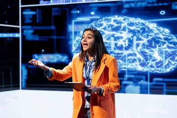 Poster - Woman using mic and tablet to do presentation at event bringing together researchers to explore developments in AI and machine learning. Engineer using device artificial intelligence summit speech