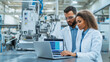 © Kateryna - Collaboration between a male and female engineer on the factory floor, with advanced machinery in the background, they are focused on the data displayed on a laptop, emphasizing th