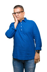 Middle age arab man wearing glasses over isolated background thinking looking tired and bored with depression problems with crossed arms.