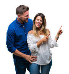 Canvas Print - Young couple in love over isolated background smiling and looking at the camera pointing with two hands and fingers to the side.