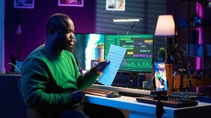 Poster - Artist pointing at musical sheet notation to explain notes on piano, teaching people to play synthesizer in home studio. Composer musician playing midi controller during online master class. Camera A.