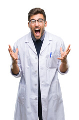 Sticker - Young handsome man wearing doctor, scientis coat over isolated background crazy and mad shouting and yelling with aggressive expression and arms raised. Frustration concept.