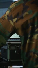 Poster - Vertical video Air force combat control agent performing tactical level surveillance in war room using laptop. Military expert in base of operations using radar on notebook to look at assault zones