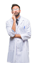 Wall Mural - Adult hispanic scientist or doctor man wearing white coat over isolated background thinking looking tired and bored with depression problems with crossed arms.