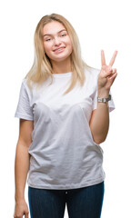 Poster - Young caucasian woman over isolated background showing and pointing up with fingers number two while smiling confident and happy.