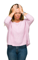 Wall Mural - Beautiful middle age adult woman wearing winter sweater over isolated background suffering from headache desperate and stressed because pain and migraine. Hands on head.