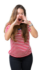 Canvas Print - Young beautiful brunette woman wearing stripes t-shirt over isolated background Shouting angry out loud with hands over mouth