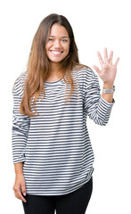 Wall Mural - Young beautiful brunette woman wearing stripes sweater over isolated background showing and pointing up with fingers number five while smiling confident and happy.