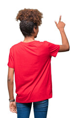 Wall Mural - Beautiful young african american woman over isolated background Posing backwards pointing behind with finger hand