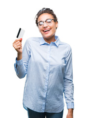 Sticker - Young african american girl holding credit card over isolated background with a happy face standing and smiling with a confident smile showing teeth