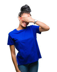 Canvas Print - Young braided hair african american girl wearing glasses over isolated background smiling and laughing with hand on face covering eyes for surprise. Blind concept.