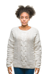 Wall Mural - Young afro american woman wearing winter sweater over isolated background with serious expression on face. Simple and natural looking at the camera.