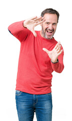 Sticker - Handsome middle age hoary senior man wearing winter sweater over isolated background Smiling doing frame using hands palms and fingers, camera perspective