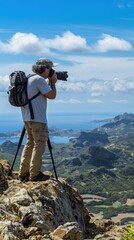 Poster - Photographer on a mountain taking a picture of a scenic landscape.