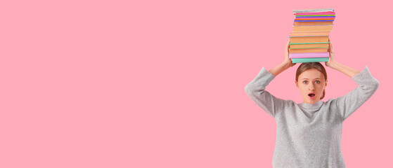 Wall Mural - Surprised female student with stack of books on his head against pink background. End of school concept