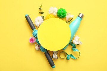 Wall Mural - Composition with blank card, sports equipment and flowers on yellow background