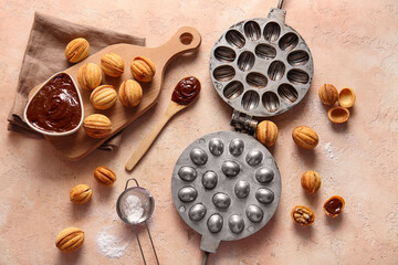 Composition with baking form, tasty walnut shaped cookies and boiled condensed milk on color background