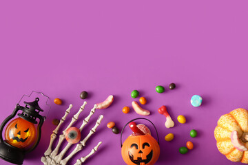 Wall Mural - Composition with decorations and treats for Halloween on purple background