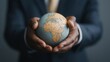 © CHOI POO - A World of Opportunity: Close-up of a businessman holding a vintage globe in his hands, symbolizing global business, international relations, and the interconnectedness of the modern world.