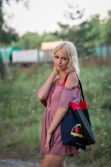 Portrait of a young beautiful blonde green-eyed girl in nature.