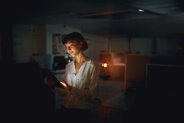 Aufkleber - Employee, dark and business with woman, tablet and happy with project, deadline and schedule. Typing, evening and creative agency with Asian worker for graphic design and internet with technology