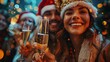 © yevgeniya131988 - Joyful coworkers don Santa hats, ringing in the New Year at the office, toasting with champagne
