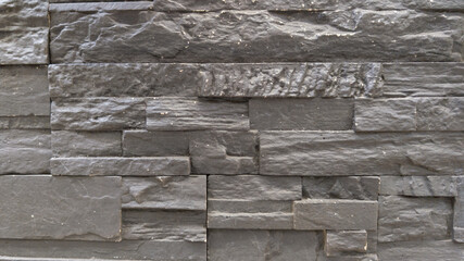 Wall Mural - ancient dark grey stone wall background of medieval brick gray horizontal stones wallpaper