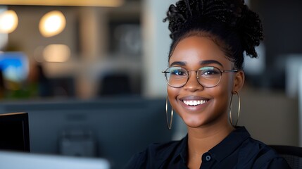 A friendly customer service representative smiling while assisting a client on a call, with a neat desk setup and a computer displaying customer details