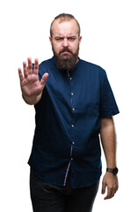 Sticker - Young caucasian hipster man over isolated background doing stop sing with palm of the hand. Warning expression with negative and serious gesture on the face.