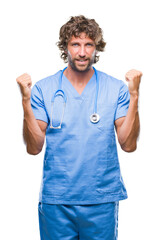 Poster - Handsome hispanic surgeon doctor man over isolated background celebrating surprised and amazed for success with arms raised and open eyes. Winner concept.