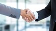 © ittipol - Two businesspeople shaking hands in a sleek office environment, symbolizing a successful partnership and collaboration,generative ai