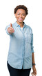 © Krakenimages.com - Young beautiful african american woman over isolated background smiling friendly offering handshake as greeting and welcoming. Successful business.