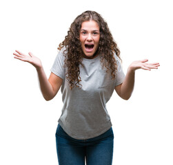 Canvas Print - Beautiful young brunette curly hair girl wearing casual look over isolated background afraid and shocked with surprise expression, fear and excited face.