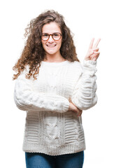 Sticker - Beautiful brunette curly hair young girl wearing winter sweater over isolated background smiling with happy face winking at the camera doing victory sign. Number two.