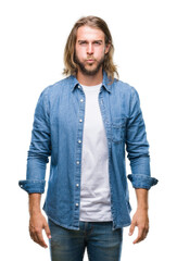 Sticker - Young handsome man with long hair over isolated background puffing cheeks with funny face. Mouth inflated with air, crazy expression.