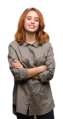 Wall Mural - Young beautiful woman over isolated background happy face smiling with crossed arms looking at the camera. Positive person.