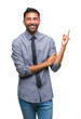 © Krakenimages.com - Adult hispanic business man over isolated background with a big smile on face, pointing with hand and finger to the side looking at the camera.
