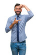 © Krakenimages.com - Adult hispanic business man over isolated background smiling making frame with hands and fingers with happy face. Creativity and photography concept.